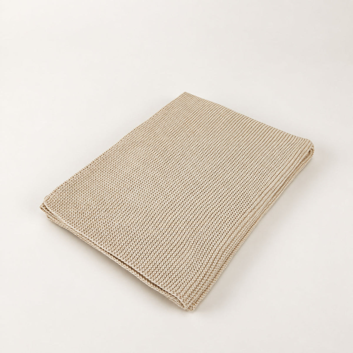 Pislak Zarja Cotton Children's Blanket in cream, folded to show its fine knitted texture.