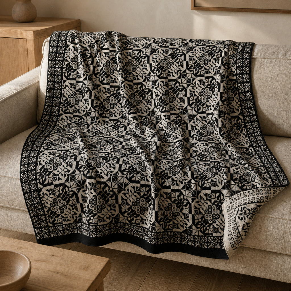Mala Planina knitted blanket in Black / Cream, lifestyle view