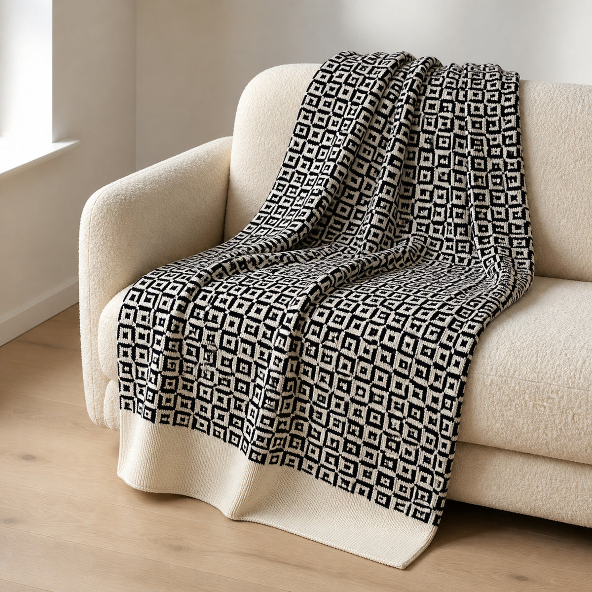 Mosaic knitted blanket – Black / Cream, lifestyle view