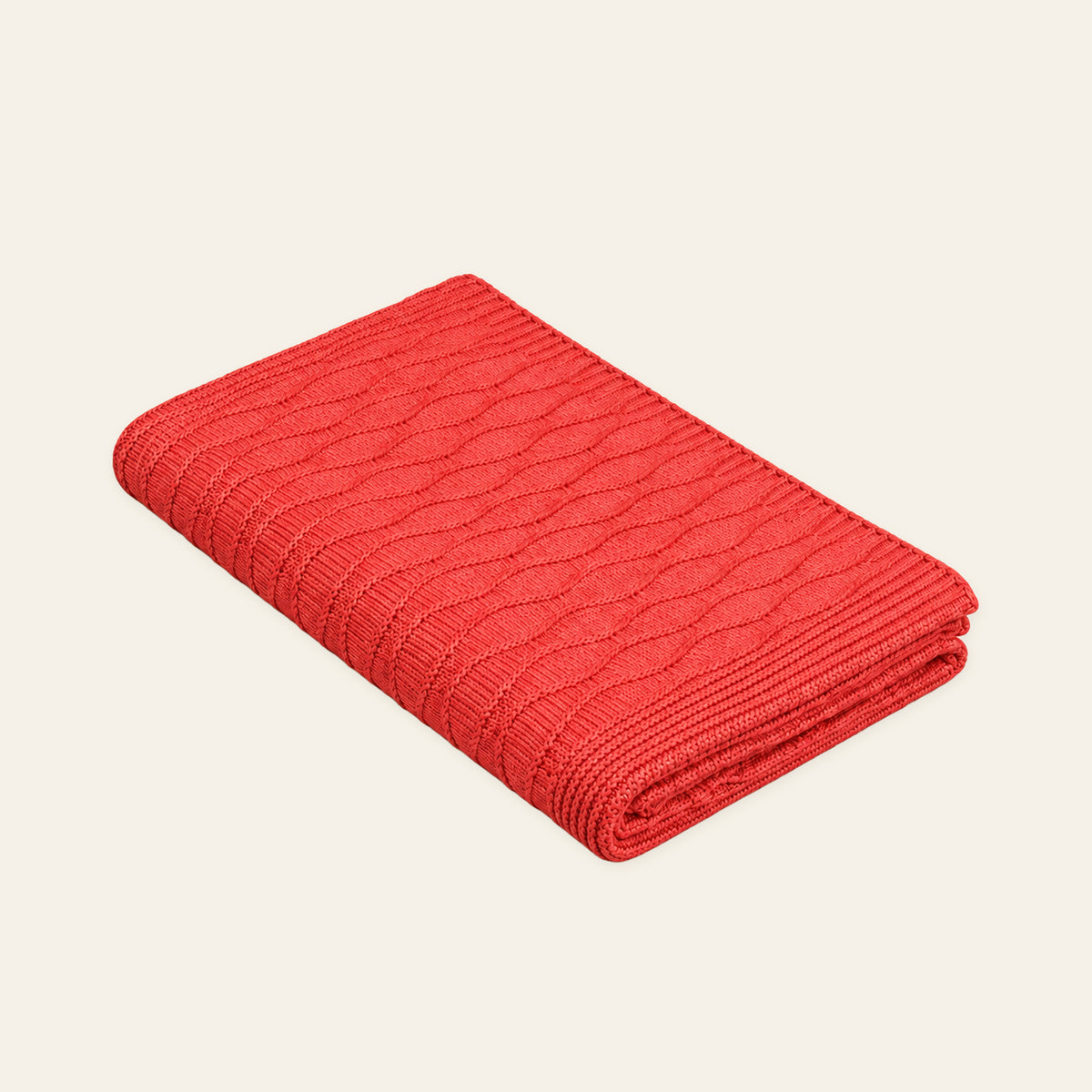 Soča knitted blanket in Coral, studio view