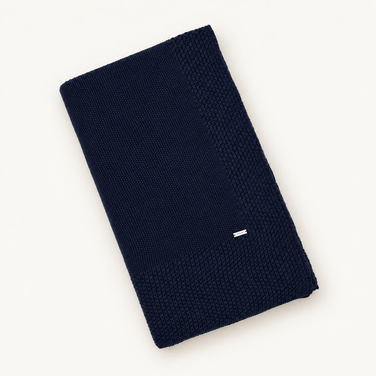 Tinka knitted blanket in Navy, folded studio view