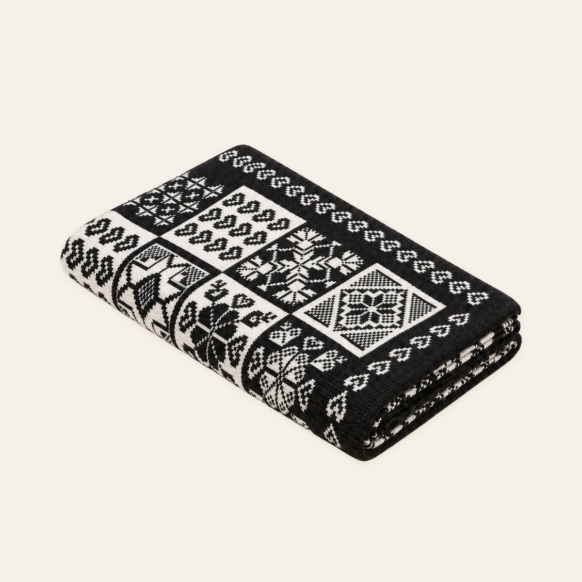 Alpine Heritage knitted blanket in Anthracite / White, studio view