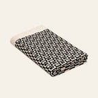 Mosaic knitted blanket – Black / Cream, studio view