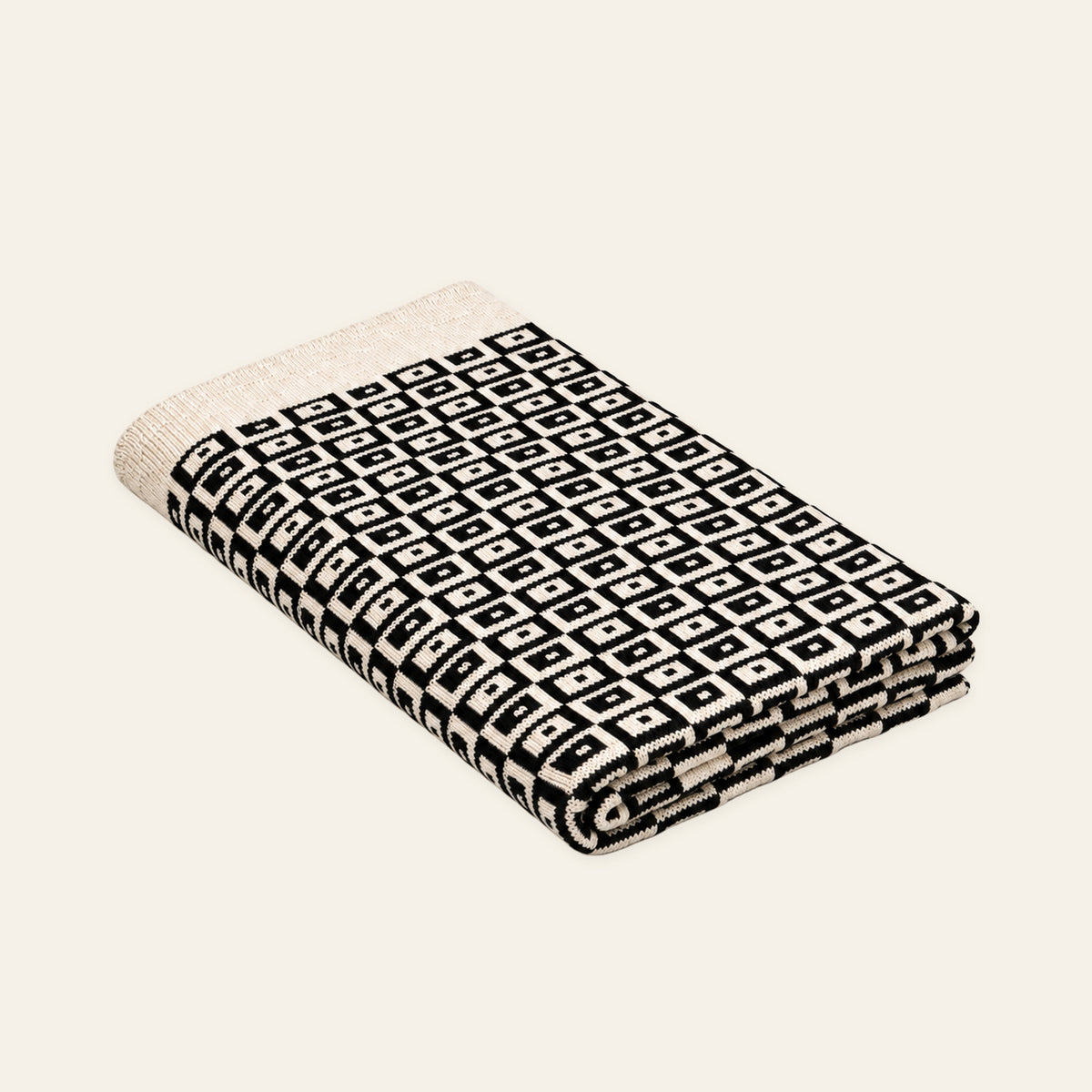 Mosaic knitted blanket – Black / Cream, studio view