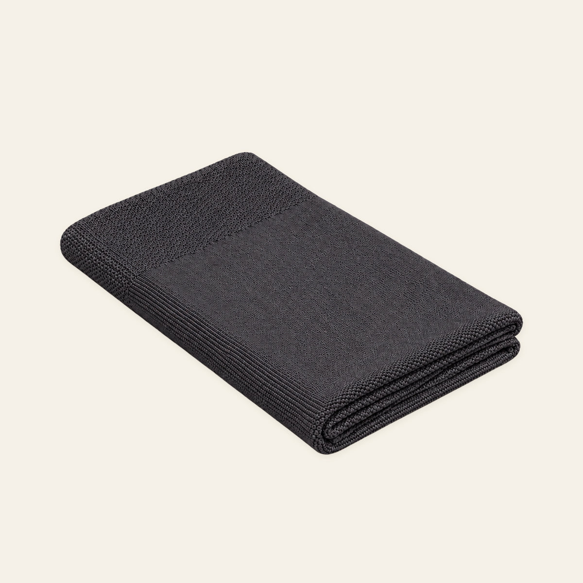 Tinka knitted blanket in Anthracite, studio view