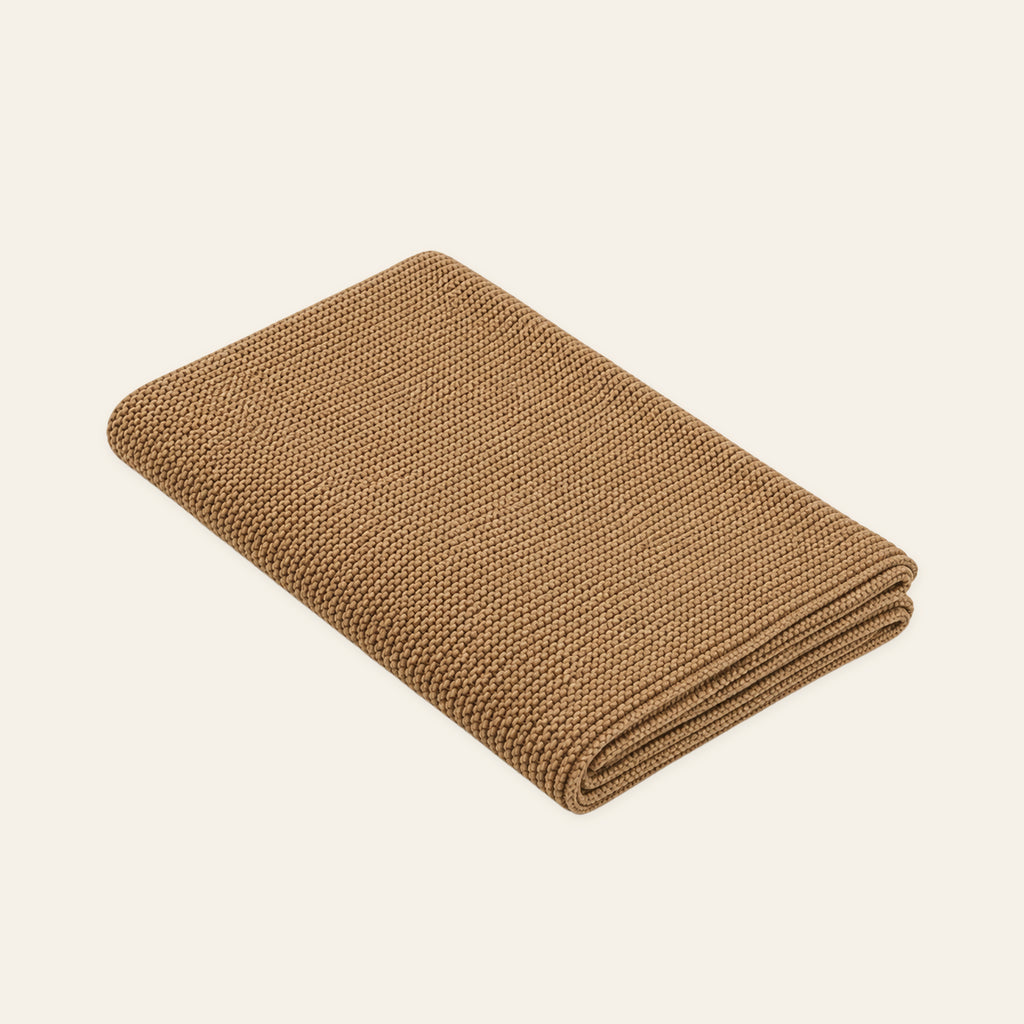 Pislak Zarja Cotton Children's Blanket in sand, folded to show its fine knitted texture.