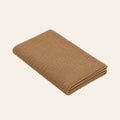 Pislak Zarja Cotton Children's Blanket in sand, folded to show its fine knitted texture.