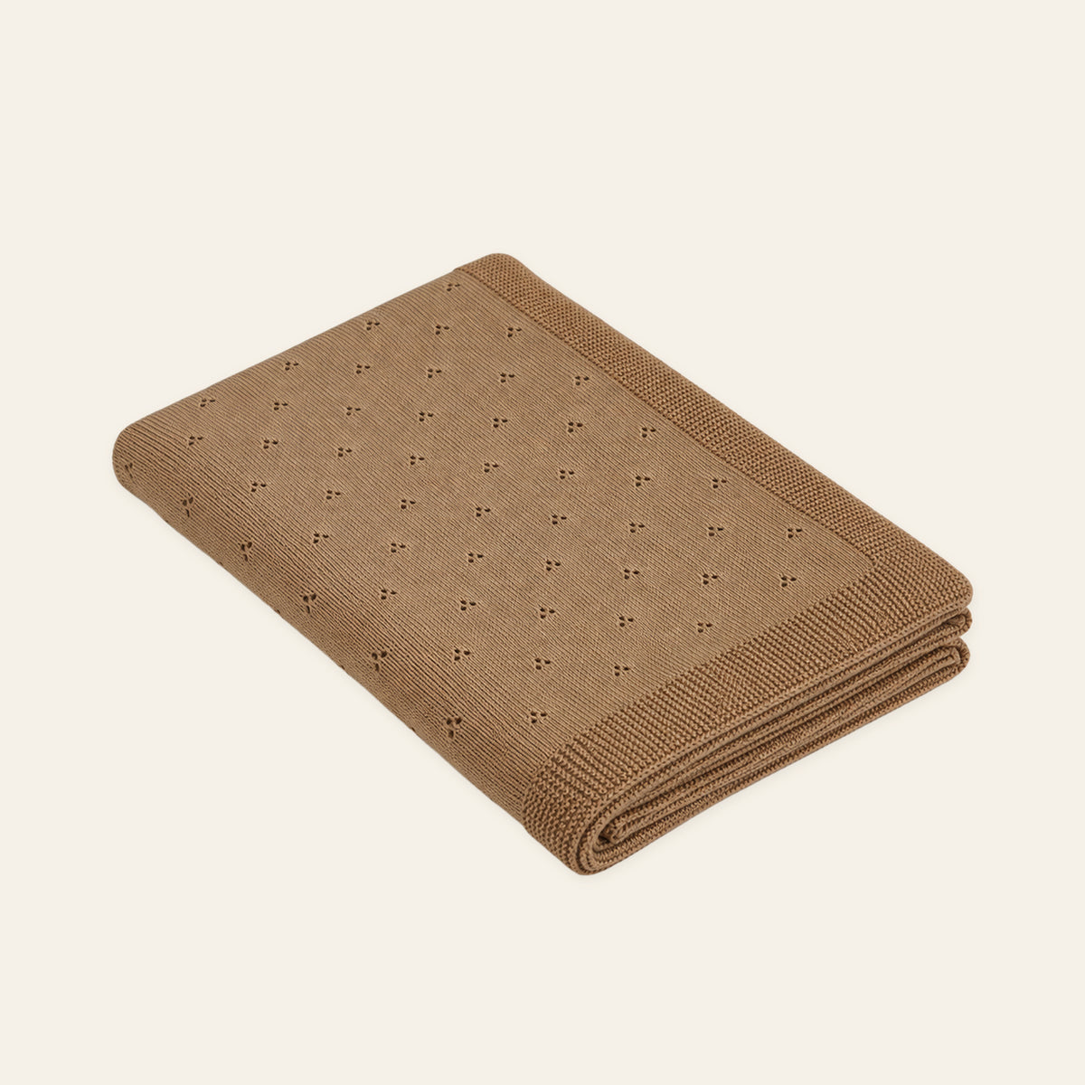 Pislak Zora Cotton Children's Blanket in sand, folded with small paired eyelets and a textured border.