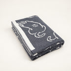 Pislak KITTY Merino-Blend Blanket in grey and cream, folded with an outlined cat motif and cream edging.