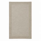 Tinka throw in light beige, shown fully unfolded with a fine knitted centre and a broad textured border.