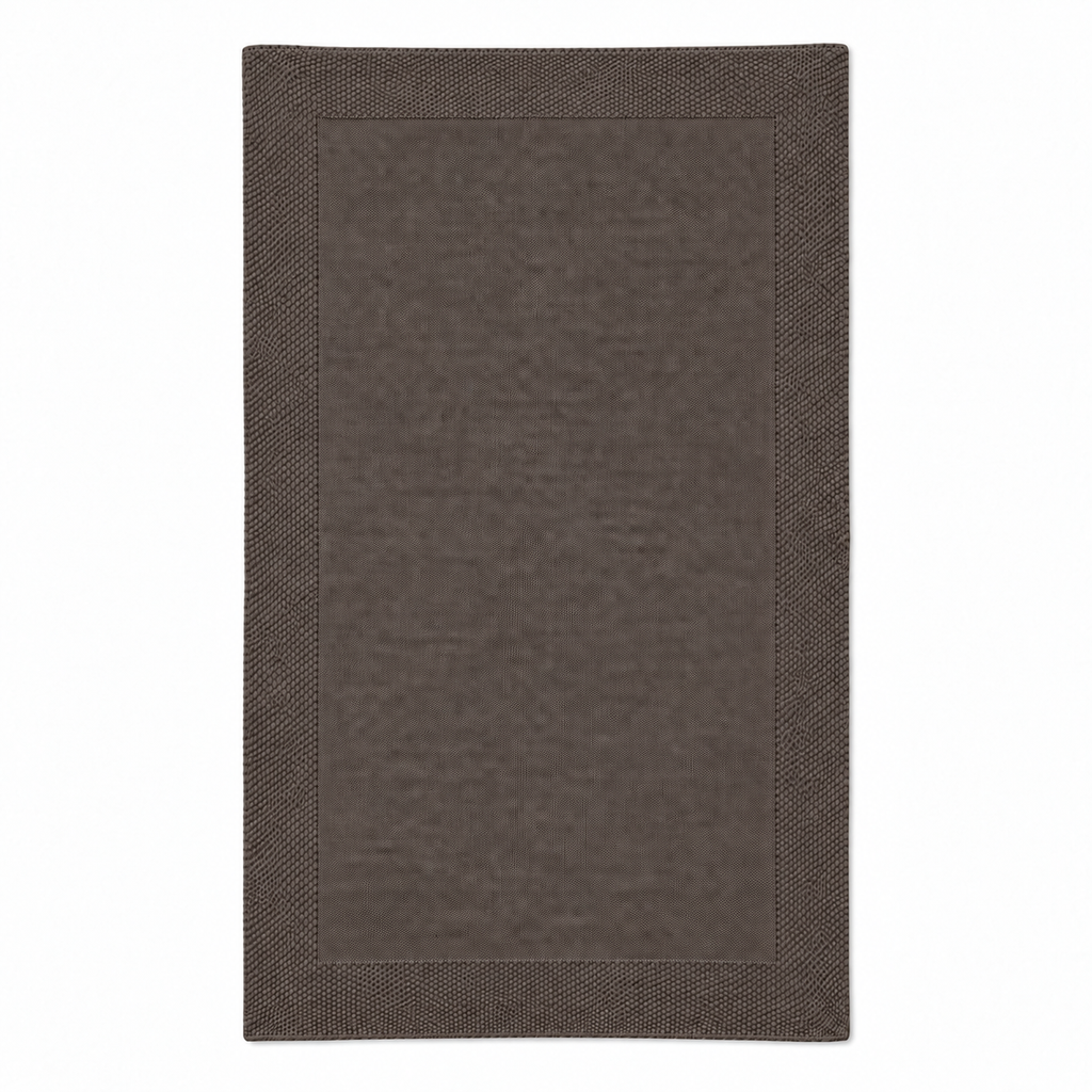 Tinka throw in taupe, shown fully unfolded with a fine knitted centre and a broad textured border.