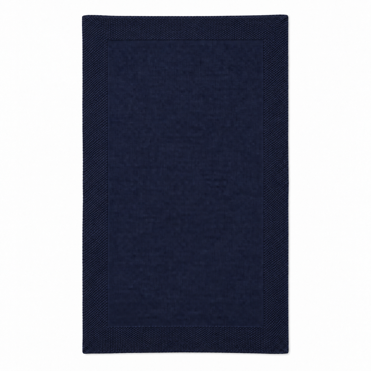 Tinka throw in dark navy, shown fully unfolded with a fine knitted centre and a broad textured border.