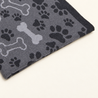 Čarli blanket in grey, detail of paw prints, bone motifs and the dark border.
